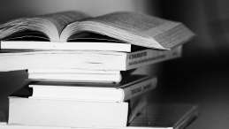 black and white photo of a stack of books